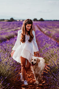 Woman with dog on lavender field