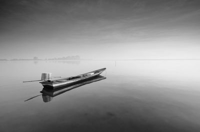 Ship moored on sea against sky