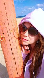 Portrait of woman wearing sunglasses at beach