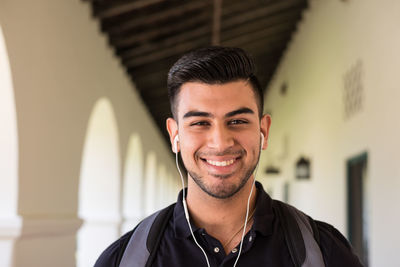 Portrait of young man with headphones smiling