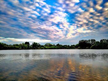 Scenic view of lake against sky at sunset