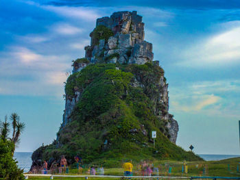 Castle by trees against sky