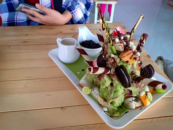 High angle view of man holding food on table