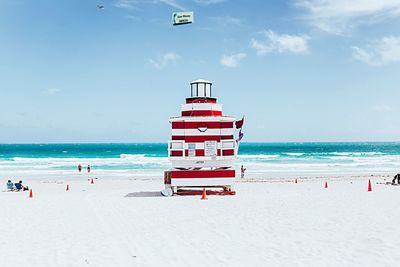 Scenic view of beach against cloudy sky