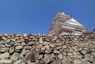 Low angle view of traditional building against clear blue sky