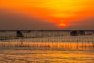 Scenic view of sea against orange sky