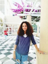 Portrait of smiling young woman standing outdoors