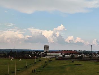 View of building on field against cloudy sky