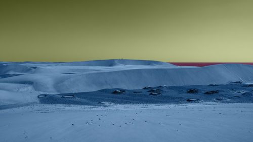 Scenic view of snowcapped mountains against clear sky