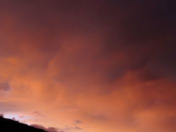 Low angle view of cloudy sky at sunset