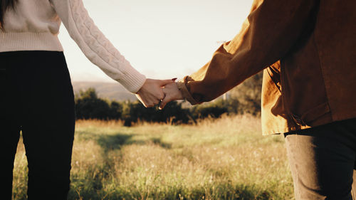 Romantic couple walks hand in hand outdoor