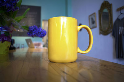 Close-up of coffee cup on table at home