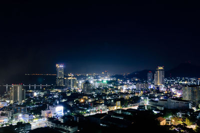 High angle view of illuminated buildings in city at night