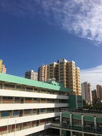 Low angle view of buildings against blue sky