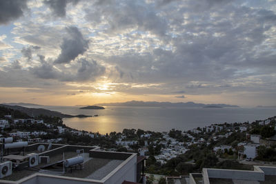 High angle shot of townscape against sky at sunset