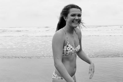 Portrait of smiling young woman on beach