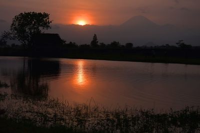 Scenic view of lake against romantic sky at sunset