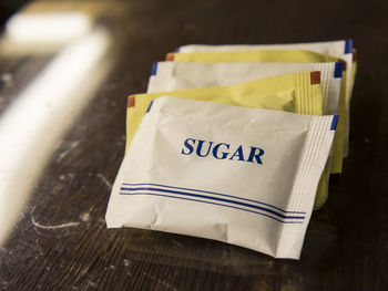 Close-up of sugar packets on table