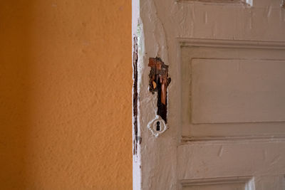 Man seen through door of building