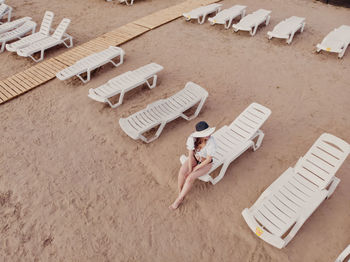 High angle view of child lying on sand