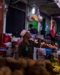 People for sale at market stall