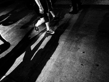 Low section of people walking on road