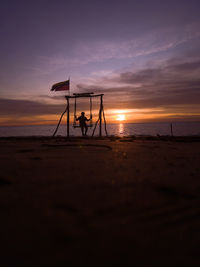 Scenic view of beach against sky during sunset