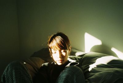 Portrait of teenage girl sitting on sofa at home