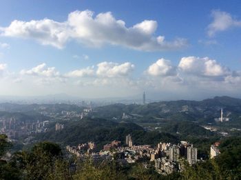 Cityscape against cloudy sky