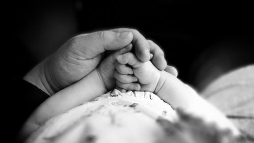 Close-up of hands of father and baby