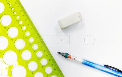 High angle view of pencils on table against white background