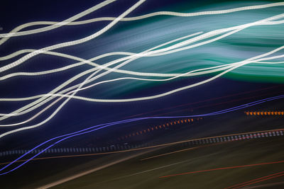 Full frame shot of light trails over black background