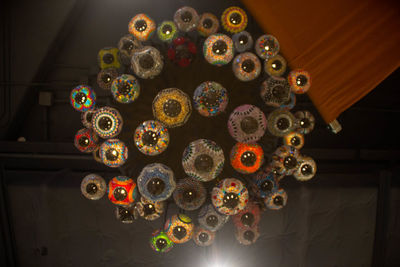 Low angle view of illuminated lighting equipment hanging on ceiling