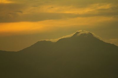 Scenic view of mountains against sky at sunset