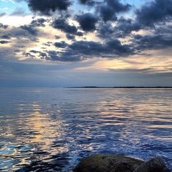 Scenic view of sea against cloudy sky