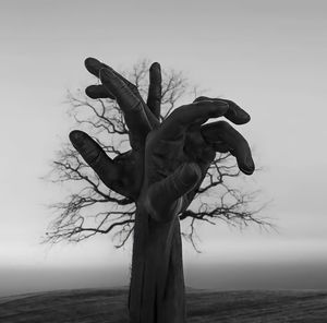 Low angle view of woman standing against sky