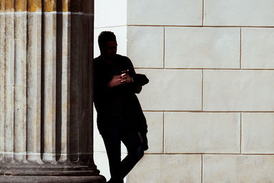 Full length of man using mobile phone