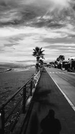 Road by sea against sky in city