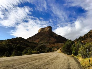 Empty road along countryside landscape