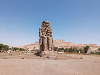 Rock formations in desert against clear blue sky