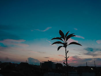 Low angle view of silhouette buildings against sky at sunset