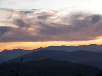 Scenic view of silhouette mountains against sky during sunset