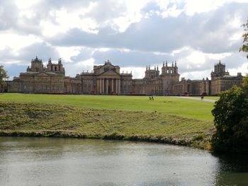 Buildings in park against cloudy sky