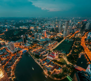 High angle view of city lit up at night