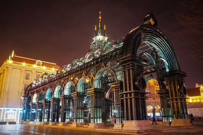 Low angle view of illuminated building against sky at night