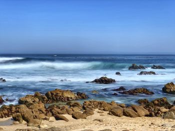 Beautiful ocean landscape of rocky coastline along scenic pacific grove with blue water abd skies