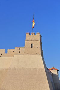 Low angle view of fort against blue sky