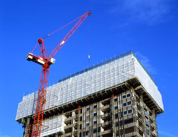 Low angle view of building under construction against sky