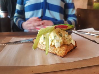 Close-up of person preparing food on table