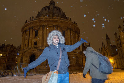 Portrait of smiling woman standing in snow